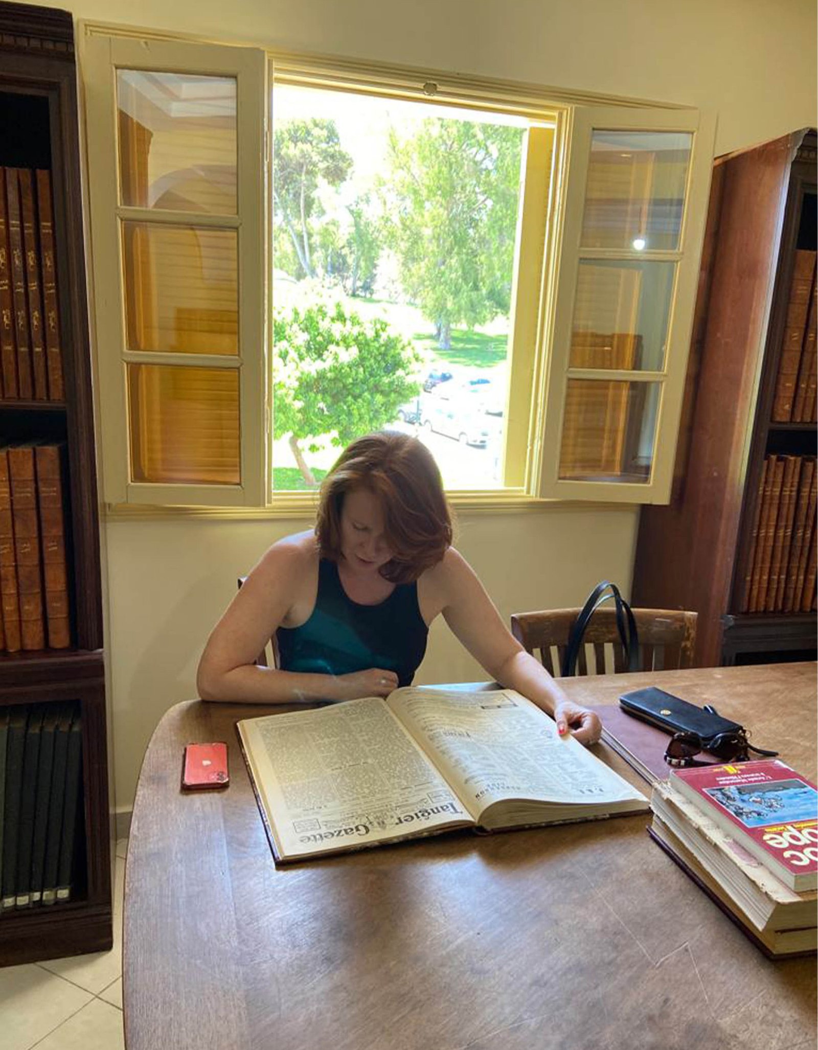Researcher consulting a book